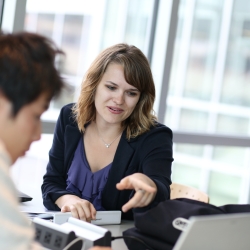 Advisor sitting and working with student